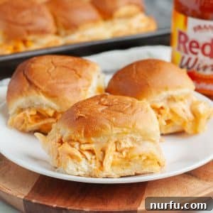 Plate with three mini chicken sandwiches.