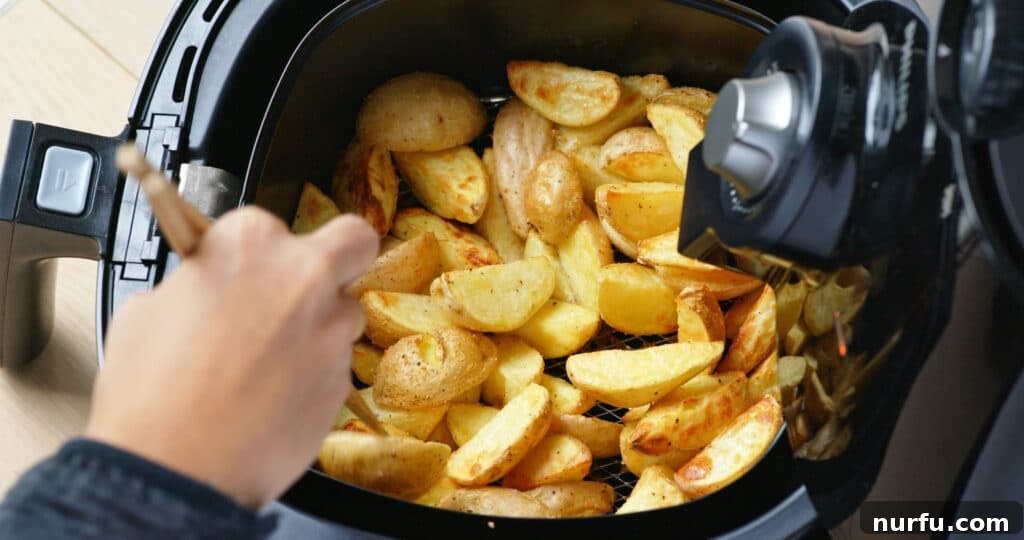 Your Guide To Optimal Air Fryer Oil 4 Air fryer basket being greased with oil