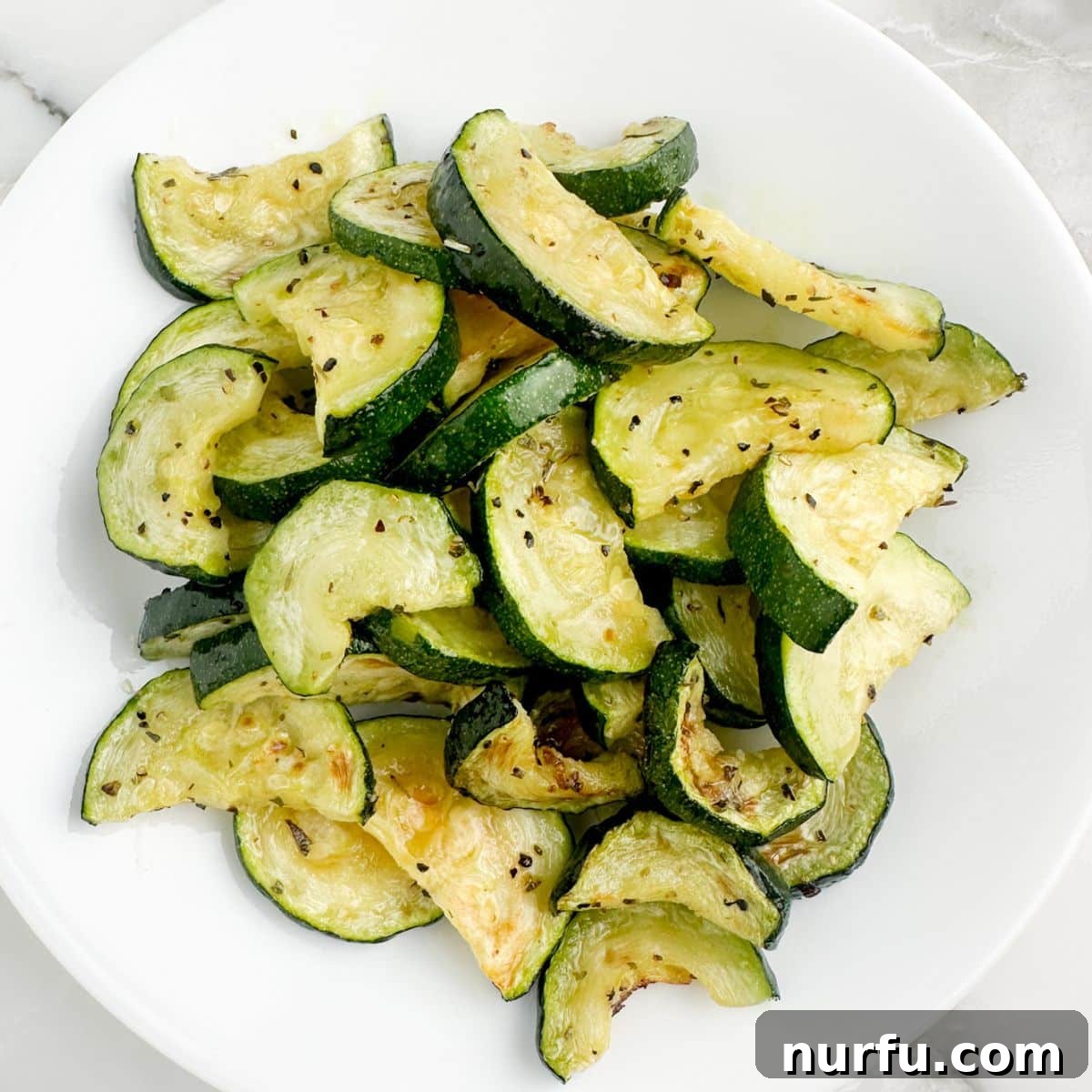 A vibrant plate of perfectly roasted air fryer zucchini, ready to be enjoyed as a healthy and delicious side dish.