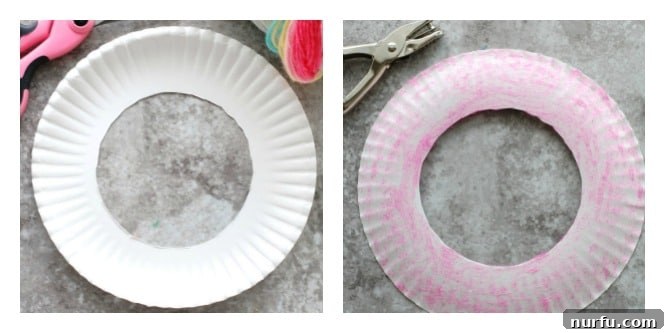 A clean, white paper plate with its center meticulously cut out, showcasing the remaining sturdy outer ring that will form the frame of a DIY dream catcher. This initial step is crucial for the craft project.