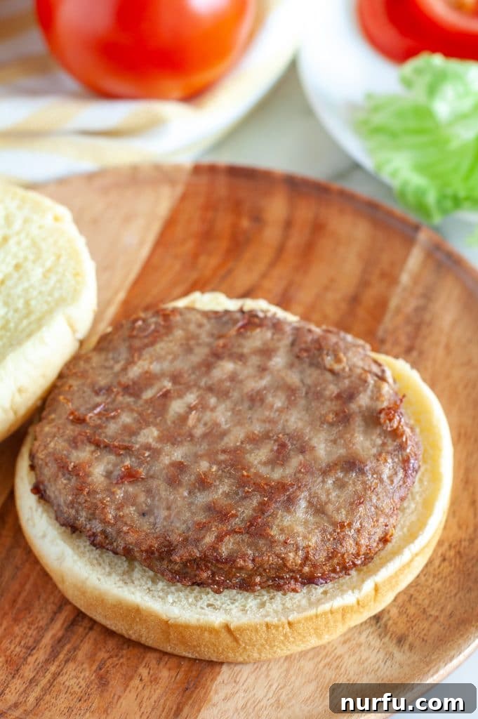 Perfect Air Fryer Frozen Turkey Burgers 4 A delicious turkey burger patty placed on the bottom half of a hamburger bun, ready to be assembled.