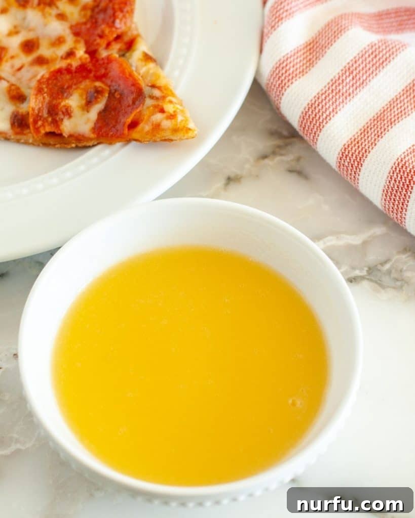 Papa John's Legendary Garlic Butter Dip 2 Bowl with melted Papa John's copycat garlic sauce, ready for dipping.