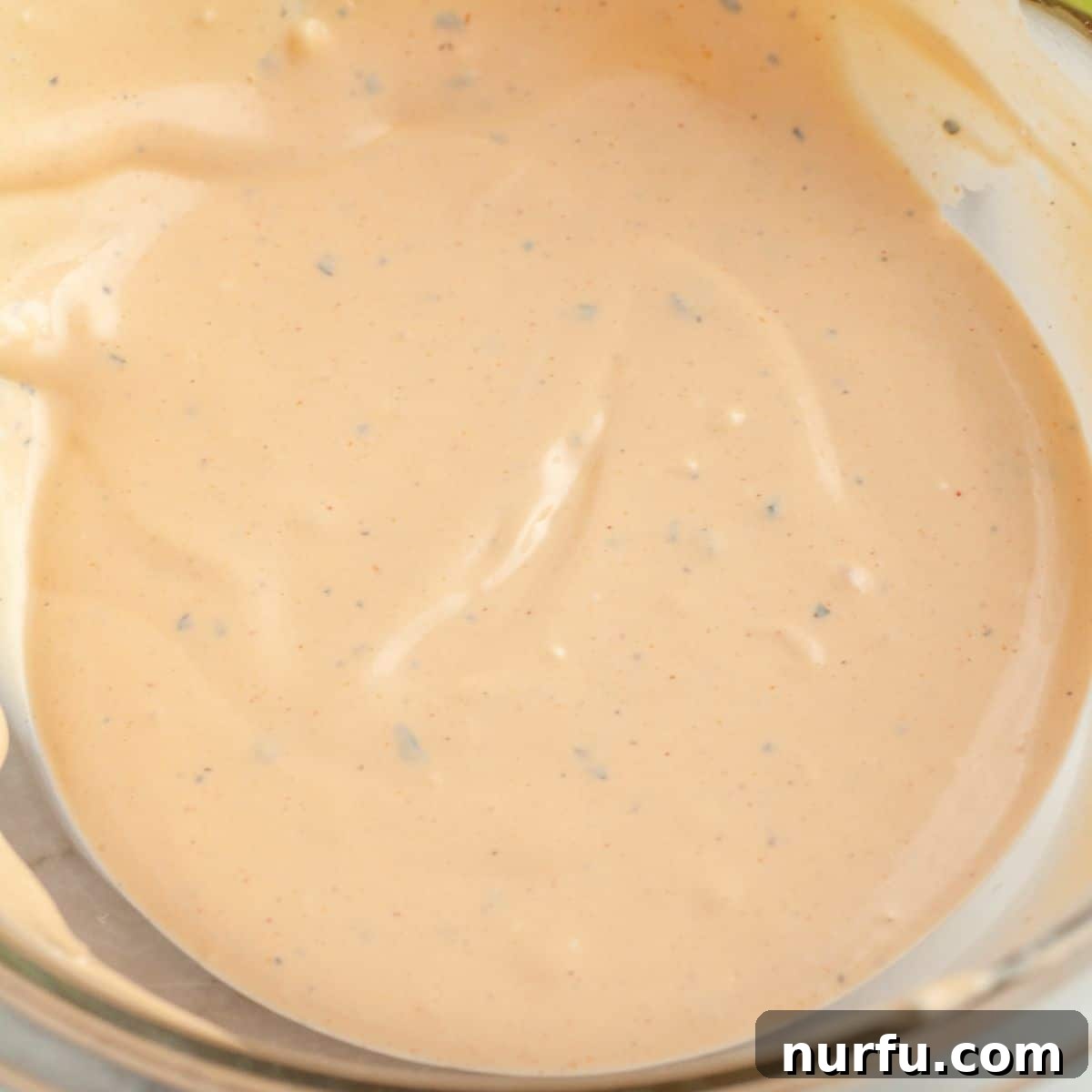 A beautifully smooth bowl of homemade buffalo ranch dip, perfectly chilled and ready for serving.