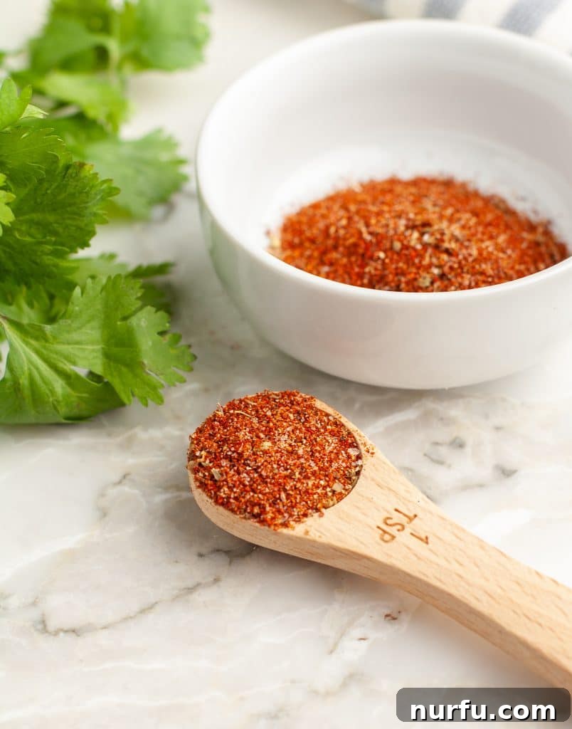 Unlock Irresistible Chicken Taco Flavor 5 Wooden spoon filled with homemade chicken taco seasoning.