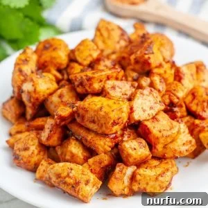 Cooked seasoned chicken on a plate.