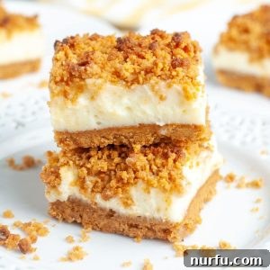 Decadent Butterscotch Cheesecake Squares 5 Stacked dessert bars with crumb topping on a plate.