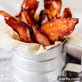 Crispy air fryer candied bacon, glistening with a sweet glaze, ready to be enjoyed.