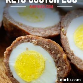 A perfectly cooked Scotch egg, revealing a hard-boiled egg wrapped in savory sausage.
