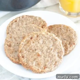 A plate featuring perfectly cooked breakfast sausage patties, golden brown and ready to eat.