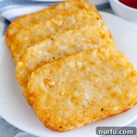 Crispy hash brown patties served on a plate, ready to be devoured.