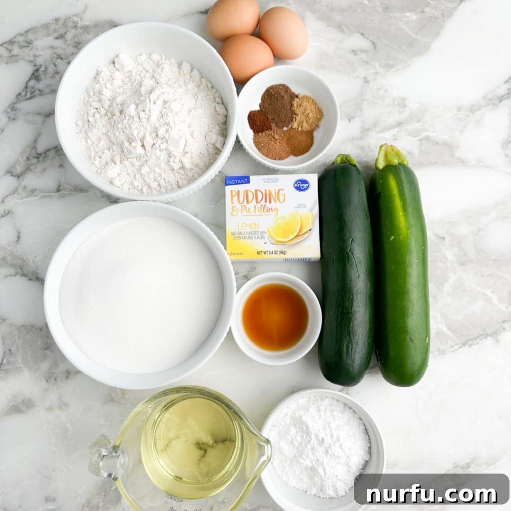 A collection of zucchini bread ingredients including fresh zucchini, flour, sugar, eggs, and lemon pudding mix arranged on a counter.