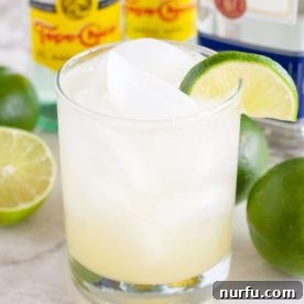 Clear Ranch Water drink in a tall glass, garnished with a vibrant lime wedge.
