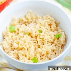 A beautifully presented bowl of microwave ramen, garnished and ready to eat.