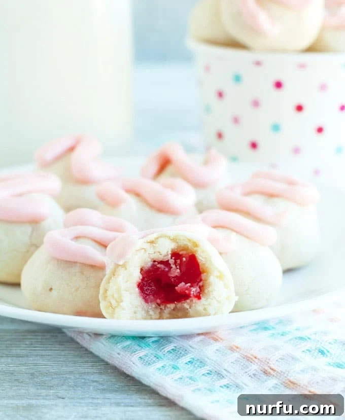 Frosted Cherry Bon Bon Cookies Close-up Close-up of a perfectly frosted Cherry Cookie, highlighting the smooth pink icing and cookie texture