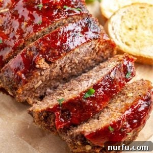 Sliced Lipton Onion Soup Meatloaf on a wooden board with toasted bread, ready to be served.