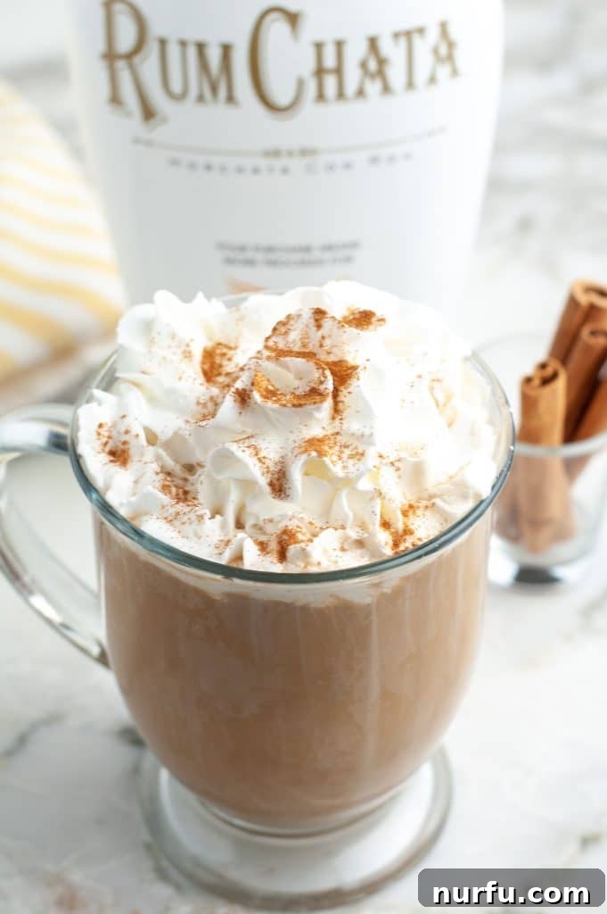 Coffee mug filled with coffee and cream.