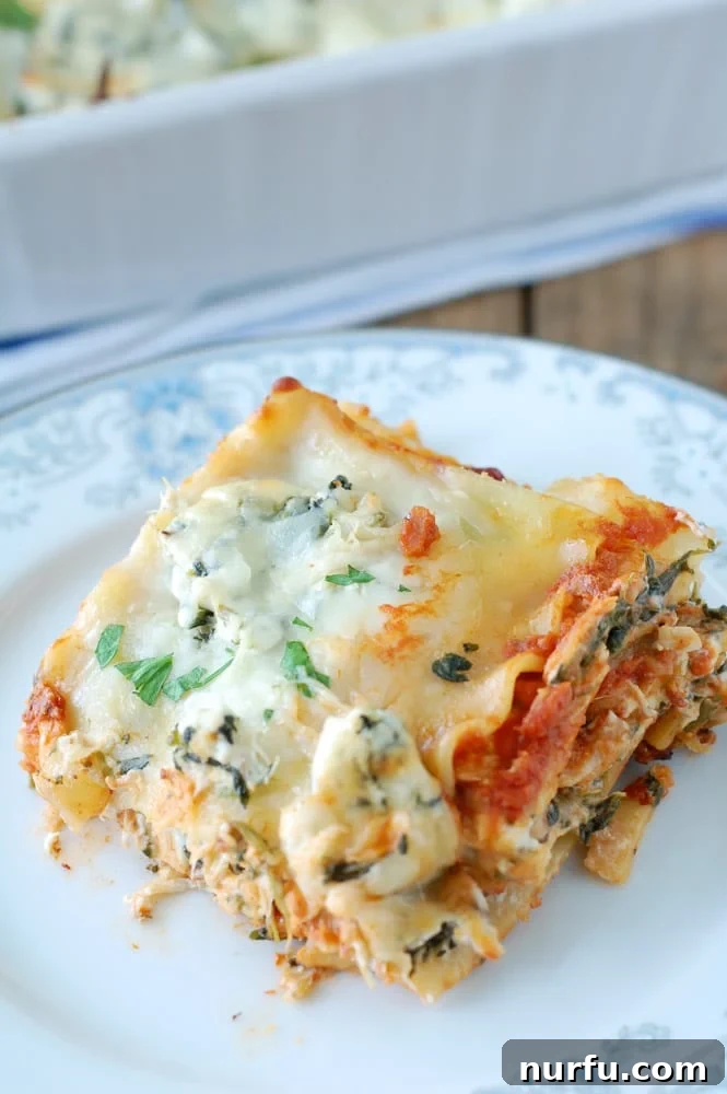 Rich Tomato Chicken Lasagna 5 A perfectly portioned slice of chicken lasagna on a white plate, ready to be enjoyed.