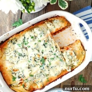 Golden-brown chicken lasagna in a casserole dish with one slice removed.