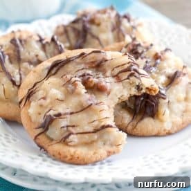 Chocolate chip cookies with frosting on a plate.