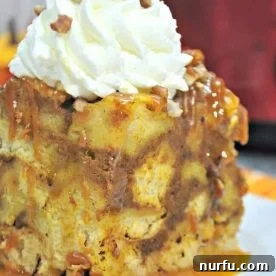 Crockpot French Toast Casserole topped with whipped cream sitting on a white plate