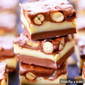 Square Pieces of Nut Goodie Bars stacked on top of each other on a plate