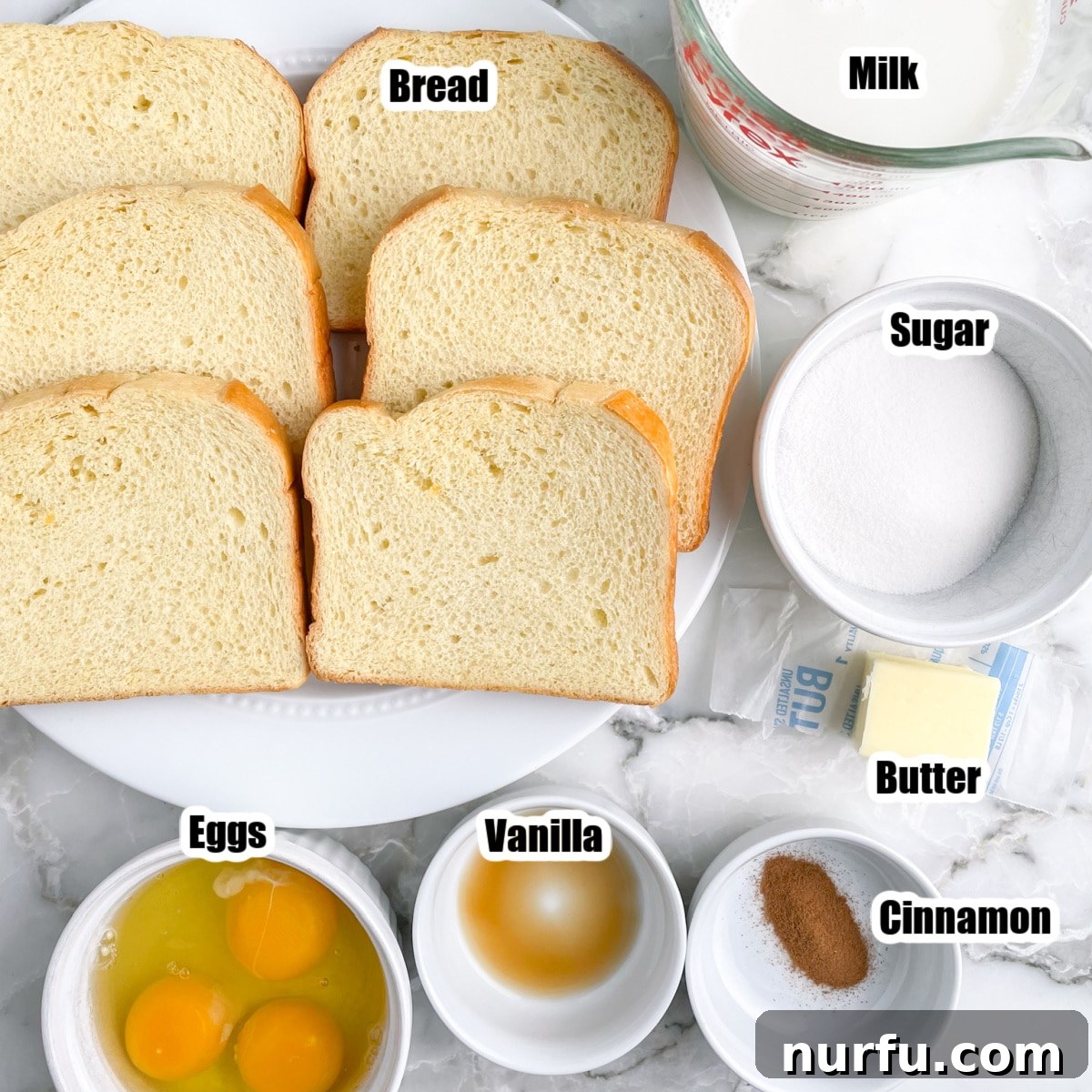 Golden French Toast Dippers 2 Plate of sliced bread, eggs, vanilla, milk, sugar, cinnamon, and butter – all ingredients ready for making French toast sticks.