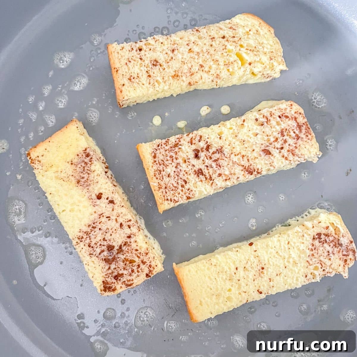 Golden French Toast Dippers 4 Skillet with french toast sticks cooking to a golden brown perfection.