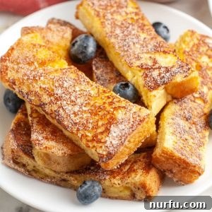 Golden French Toast Dippers 6 Plate of french toast sticks, beautifully arranged and ready for serving.