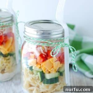 Jar filled with pasta salad.