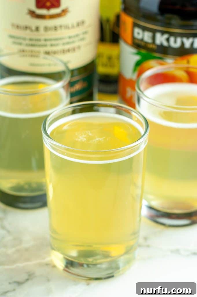 Your Guide to Green Tea Shots 2 Three shot glasses filled with the vibrant green tea shot, ready to be served.