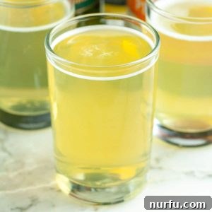 Shot glasses filled with the vibrant green Green Tea Shot.