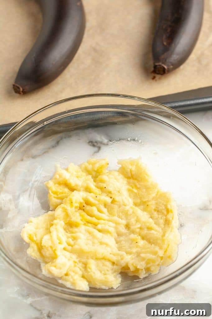 Four Simple Methods to Ripen Bananas Fast 6 A bowl of freshly mashed bananas, ready for baking.