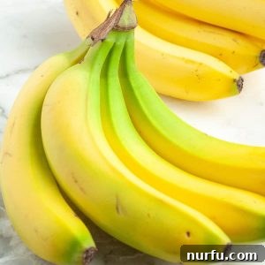 Four Simple Methods to Ripen Bananas Fast 7 A bunch of bananas on a table, signifying a recipe for ripening them.