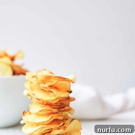 A stack of golden, crispy homemade air fryer potato chips.