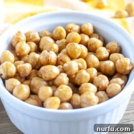 A bowl filled with perfectly roasted and crispy chickpeas, seasoned and ready to eat.