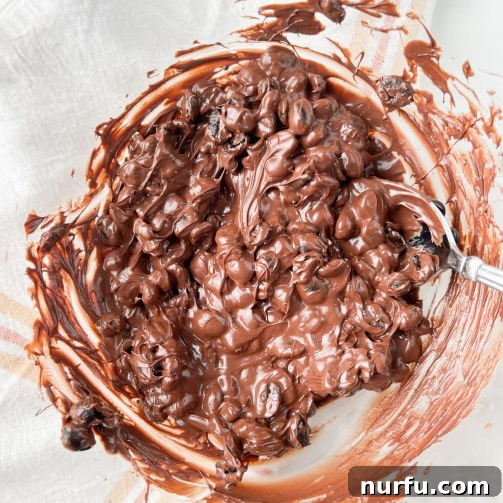 Crafting Perfect Chocolate Espresso Beans 4 Bowl of rich, melted chocolate with whole espresso beans being stirred in.