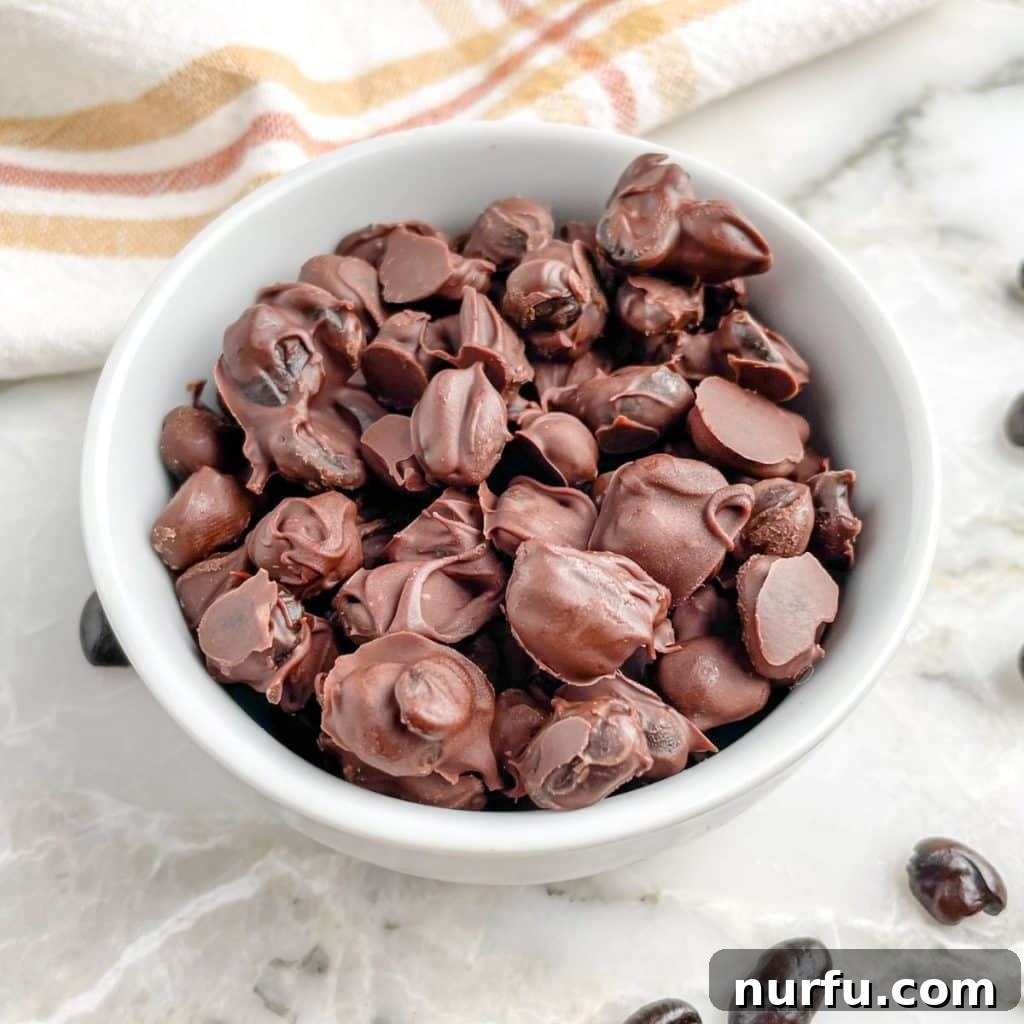 Crafting Perfect Chocolate Espresso Beans 6 Close-up of a bowl filled with various chocolate covered coffee beans.