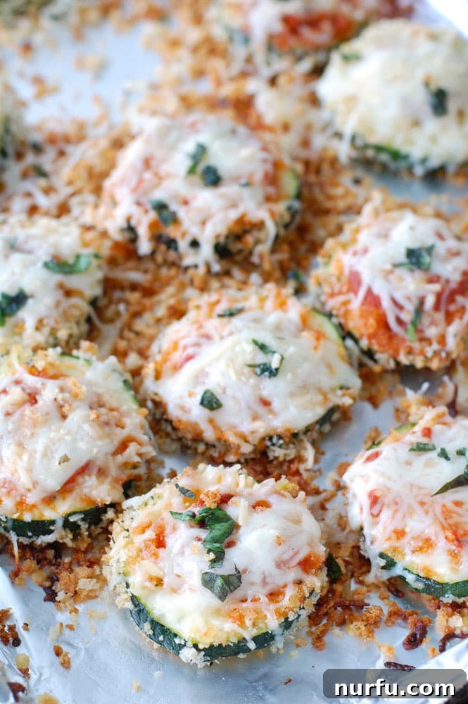 Cheesy Baked Zucchini Parmesan 3 Baked Zucchini Parmesan with golden crust and melted cheese, ready to be enjoyed.