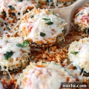 Cheesy Baked Zucchini Parmesan 5 Slices of zucchini covered in melted cheese.