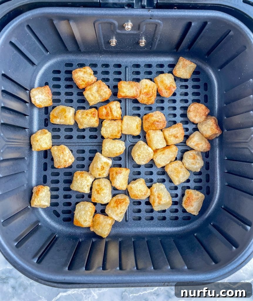 Crispy Air Fryer Cauliflower Gnocchi 5 Perfectly cooked, golden-brown cauliflower gnocchi inside the air fryer basket after cooking.