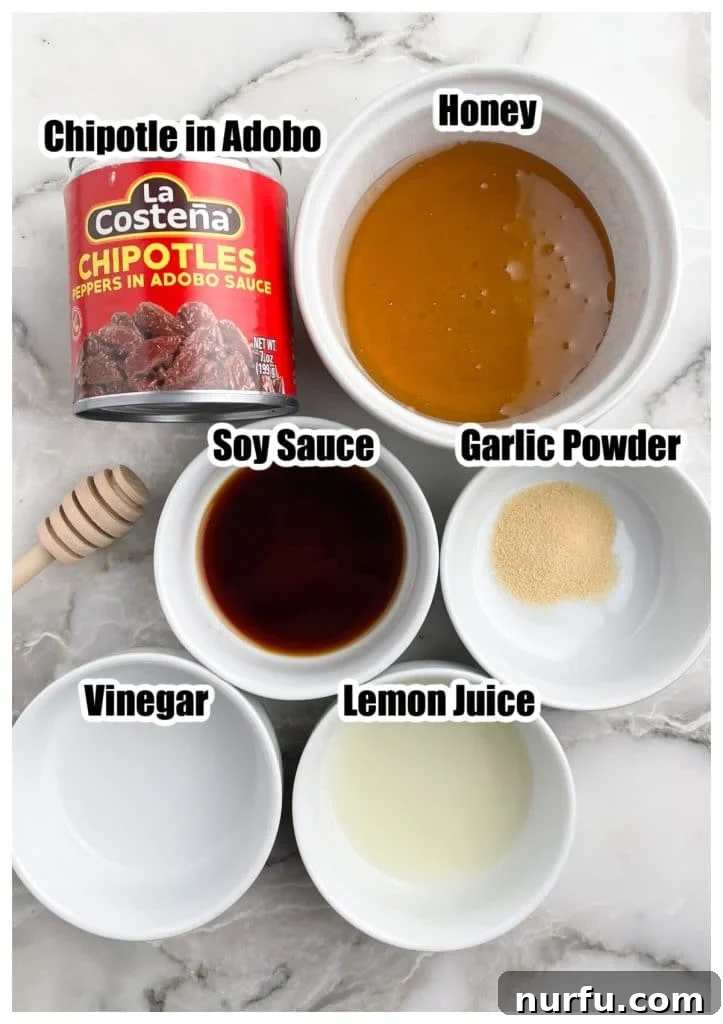 Sweet and Smoky Honey Chipotle Sauce 3 Individual ingredients for honey chipotle sauce: a can of chipotle in adobo, a bowl of honey, soy sauce, garlic powder, vinegar, and lemon juice.
