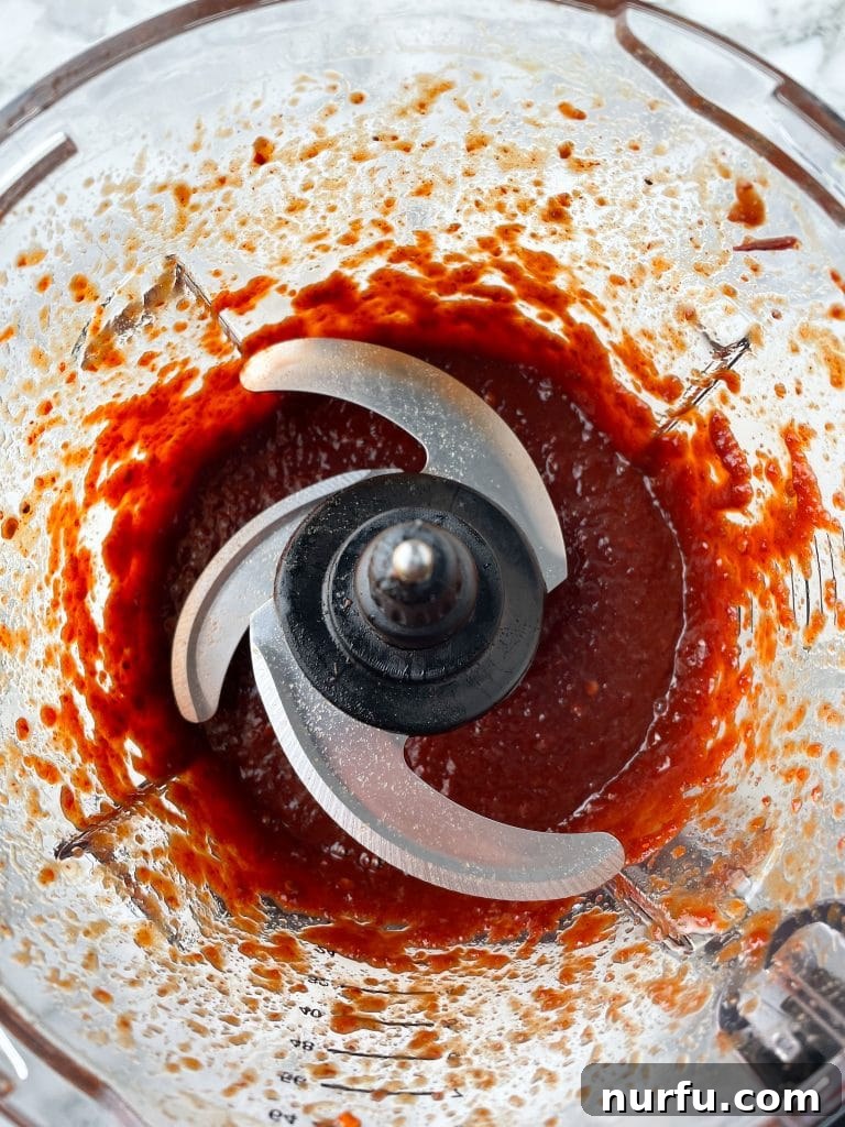 Sweet and Smoky Honey Chipotle Sauce 5 Food processor filled with the blended, smooth, red honey chipotle sauce.