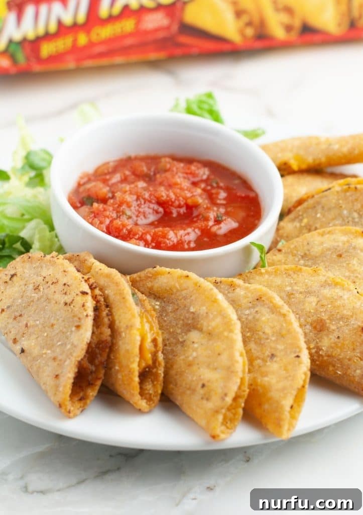 Perfect Air Fryer Frozen Mini Tacos Every Time 2 A plate brimming with golden-brown, crispy mini tacos, ready to be served. Ideal for game day or any gathering.