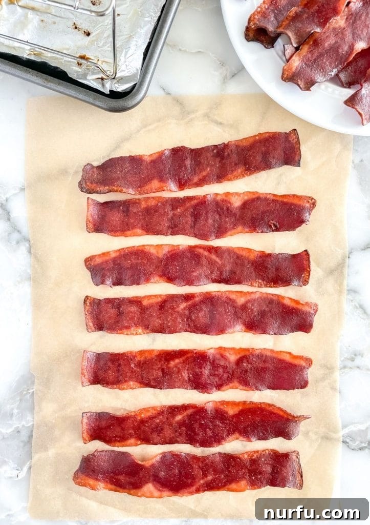 Crispy Oven Turkey Bacon 2 Crispy oven-baked turkey bacon arranged on a baking sheet, ready to be served for a delicious breakfast.