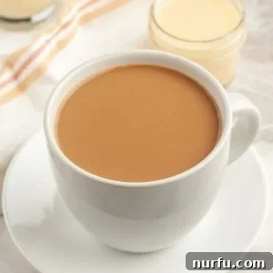 Cup of coffee with glass of cream.