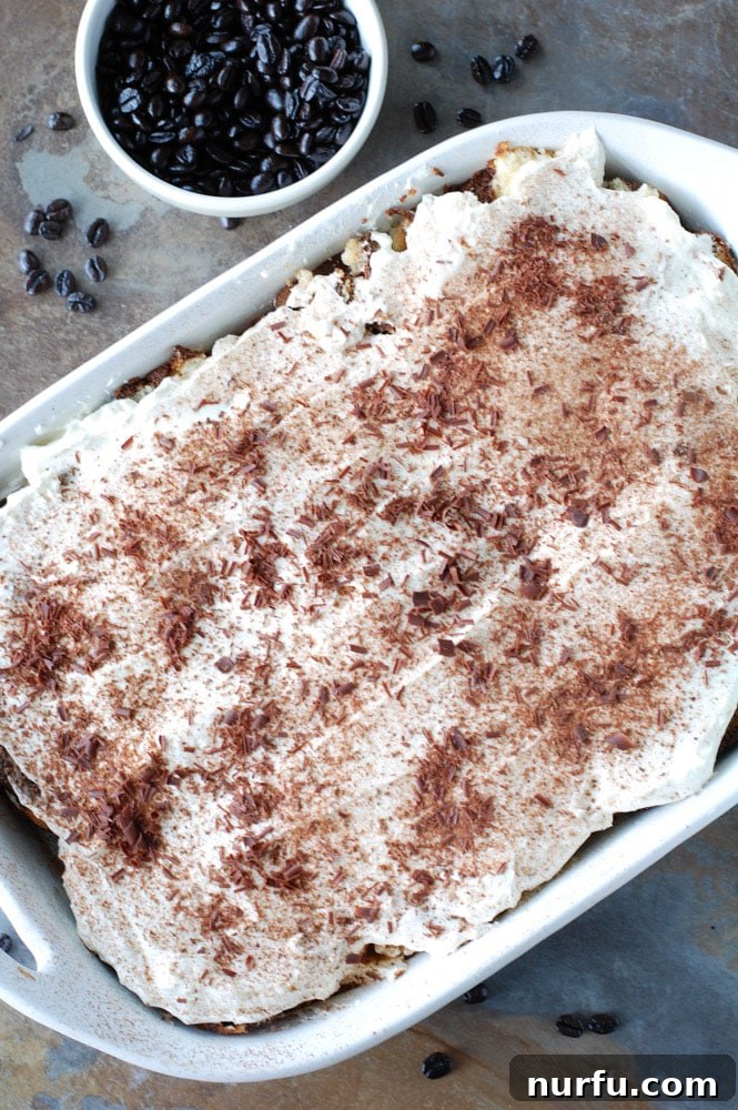 Pound Cake Tiramisu in Dish A full casserole dish of pound cake tiramisu, showcasing the layered structure of cake and cream, ready to be served.