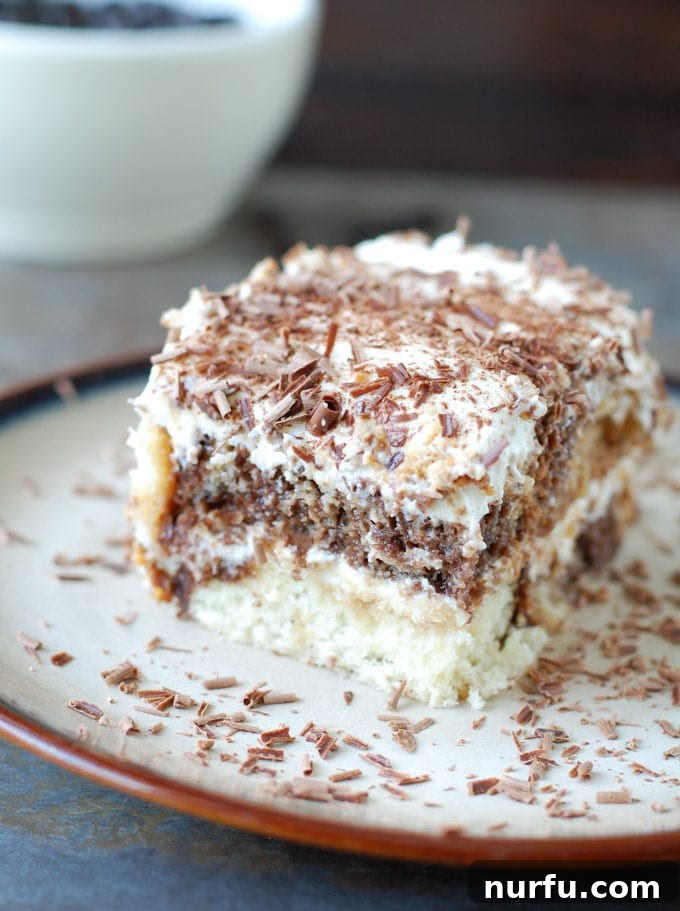Best Pound Cake Tiramisu Serving A close-up of a serving of pound cake tiramisu on a plate, showing the creamy layers, coffee-soaked cake, and a dusting of cocoa powder, ready to be enjoyed.