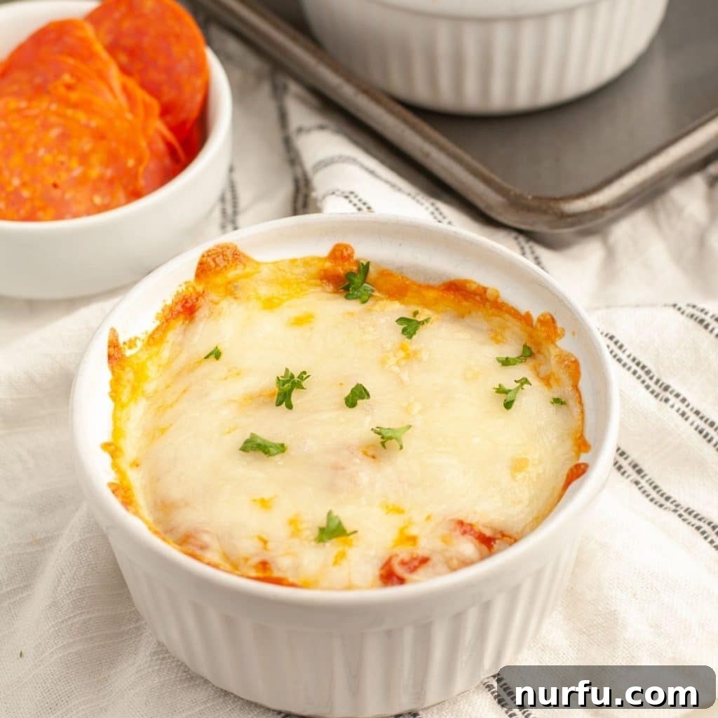 Ultimate Easy Pizza Bowl 6 A small, individual pizza bowl with perfectly melted, bubbly cheese and rich sauce, fresh out of the oven.