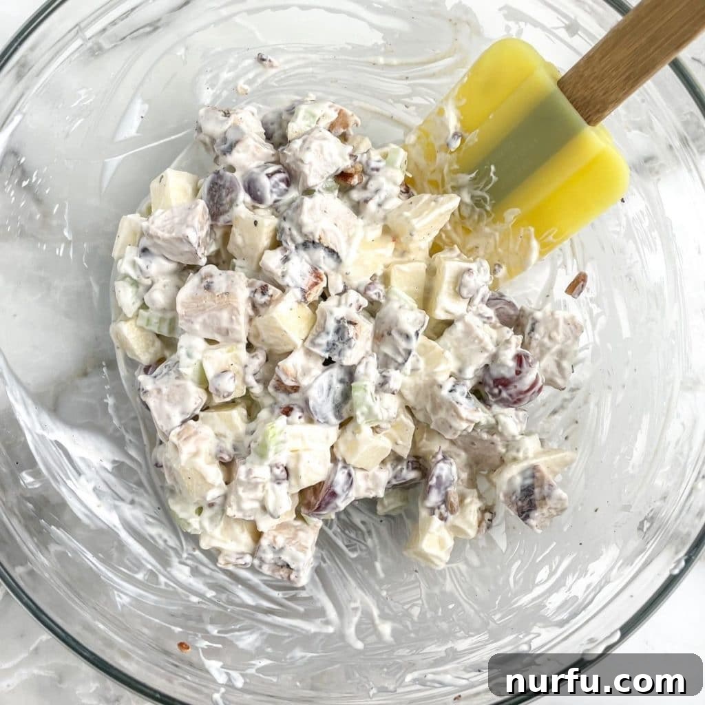 Arby's Style Homestyle Chicken Salad 6 Bowl of chicken salad with a spatula.
