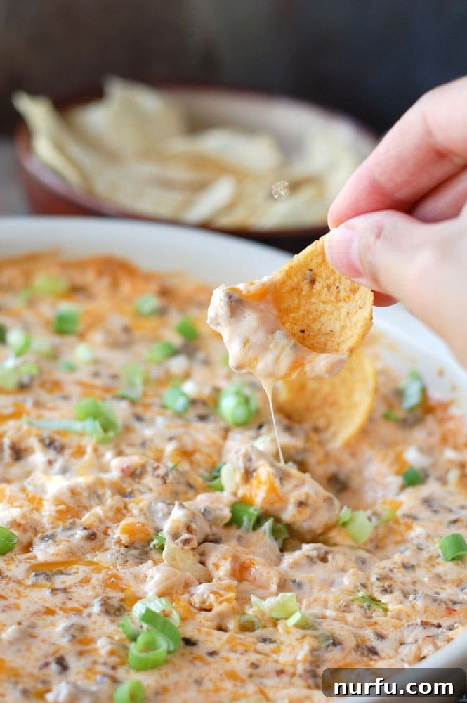 15 Next-Level Dips for Your Best Party Yet 3 Creamy Hot Beer Cheese and Sausage Dip, perfect for game day appetizers.